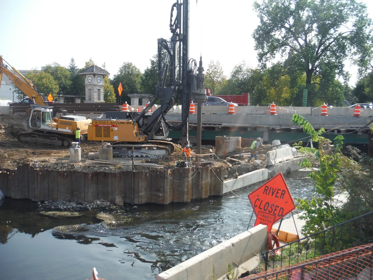 A construction site with a crane and water