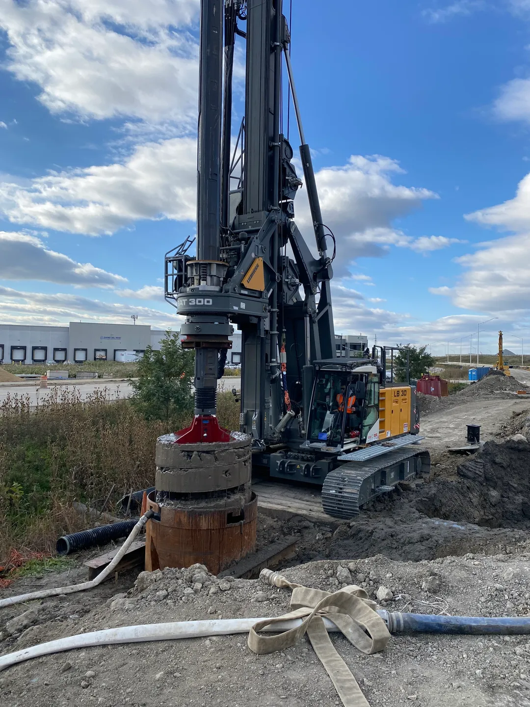 A large machine is on the ground near some dirt.