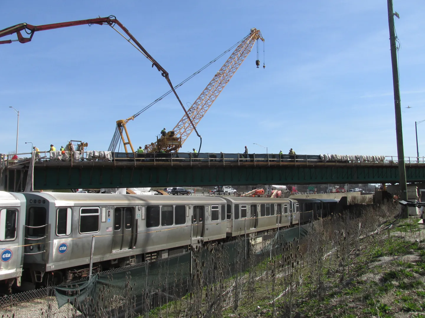 A train is on the tracks near a bridge.