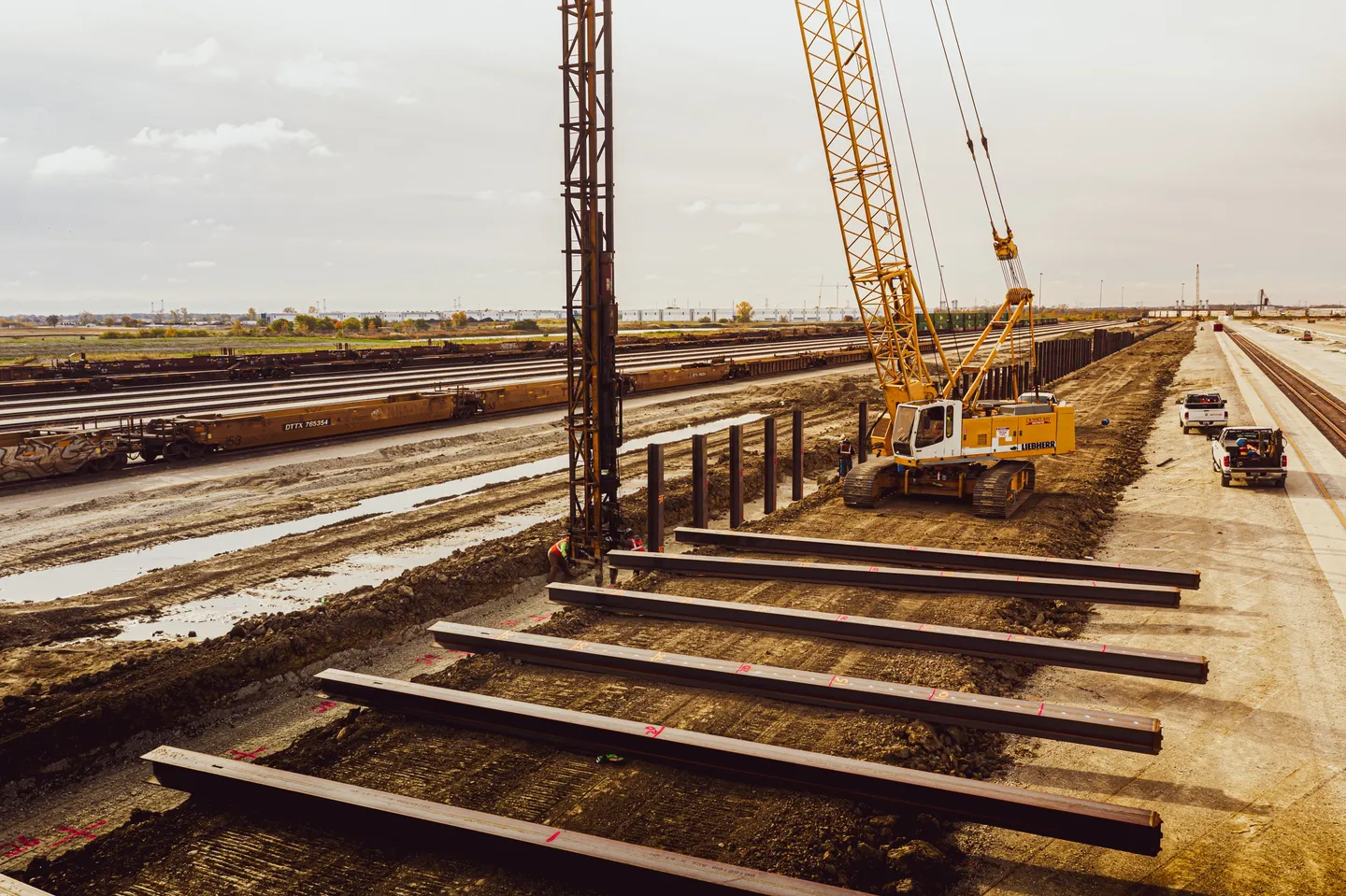 A crane is on the tracks near some railroad tracks.