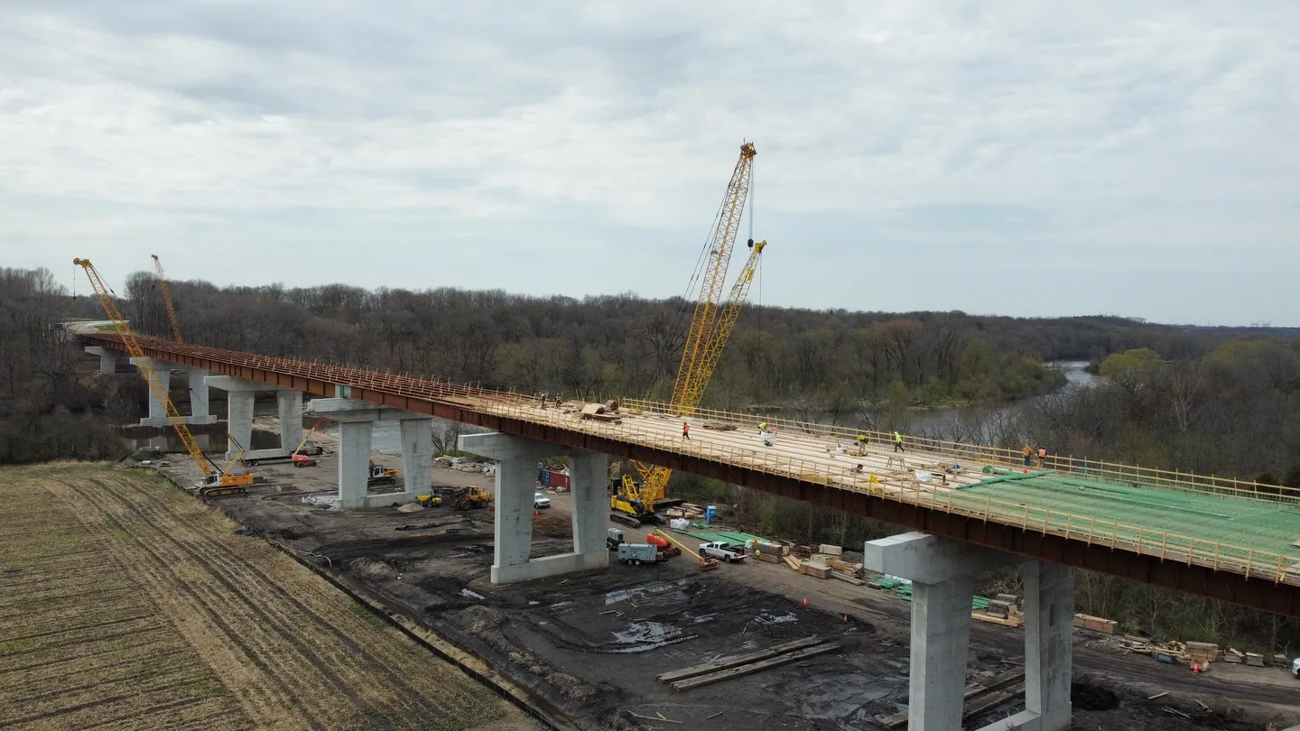 A bridge that is under construction with trees in the background.