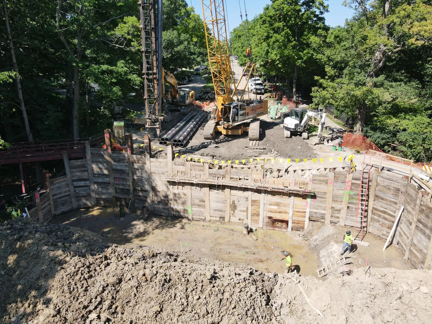 A construction site with workers and machinery in the background.